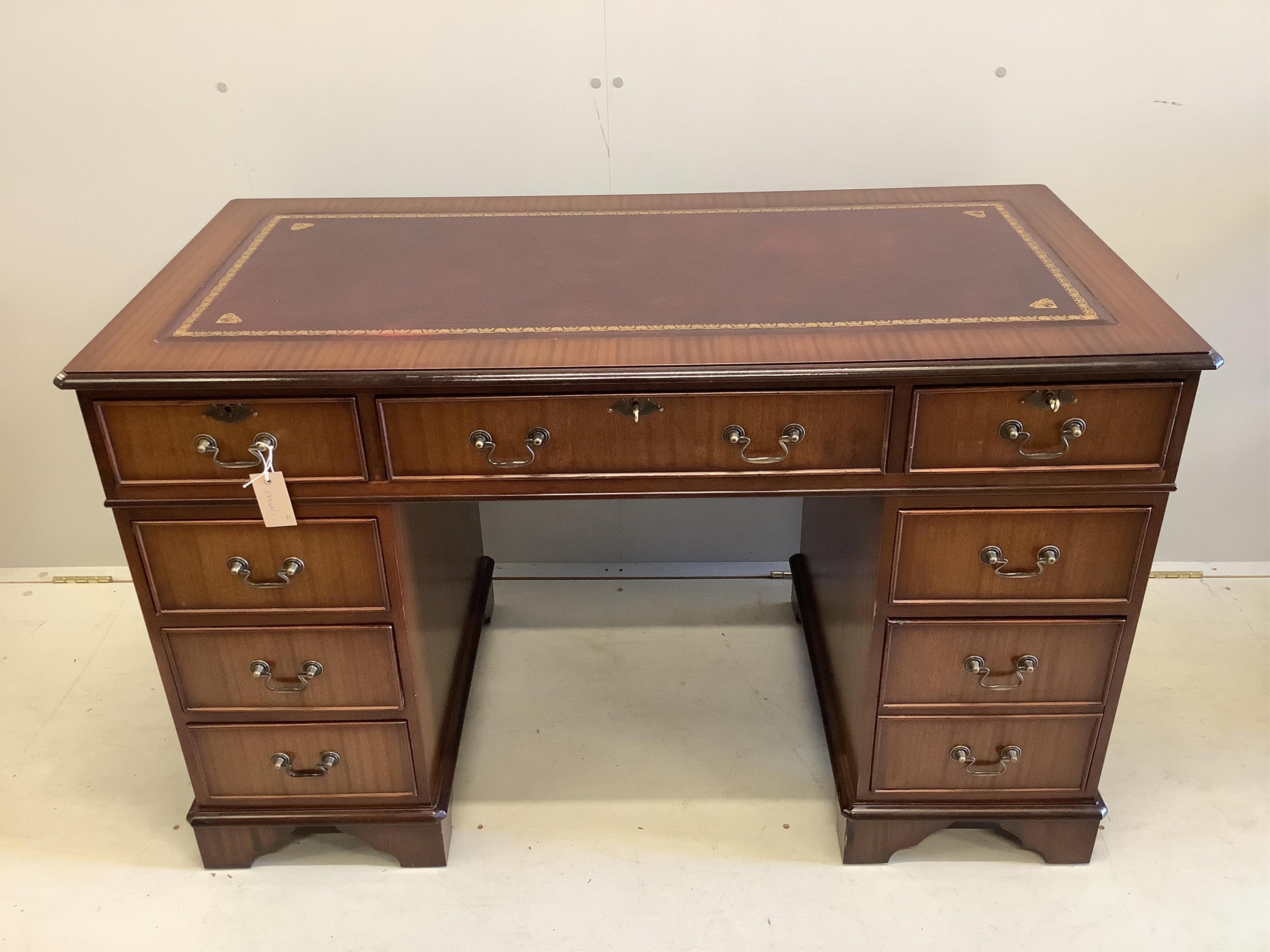 A reproduction Victorian style beech and burgundy leather swivel desk chair, together with a reproduction mahogany pedestal desk, width 121cm, depth 61cm, height 76cm